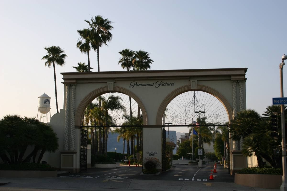 An ornate arched studio gate with wrought-iron doors