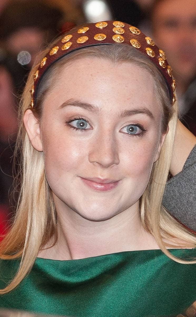 Saoirse Ronan with a studded headband and a green dress, smiling