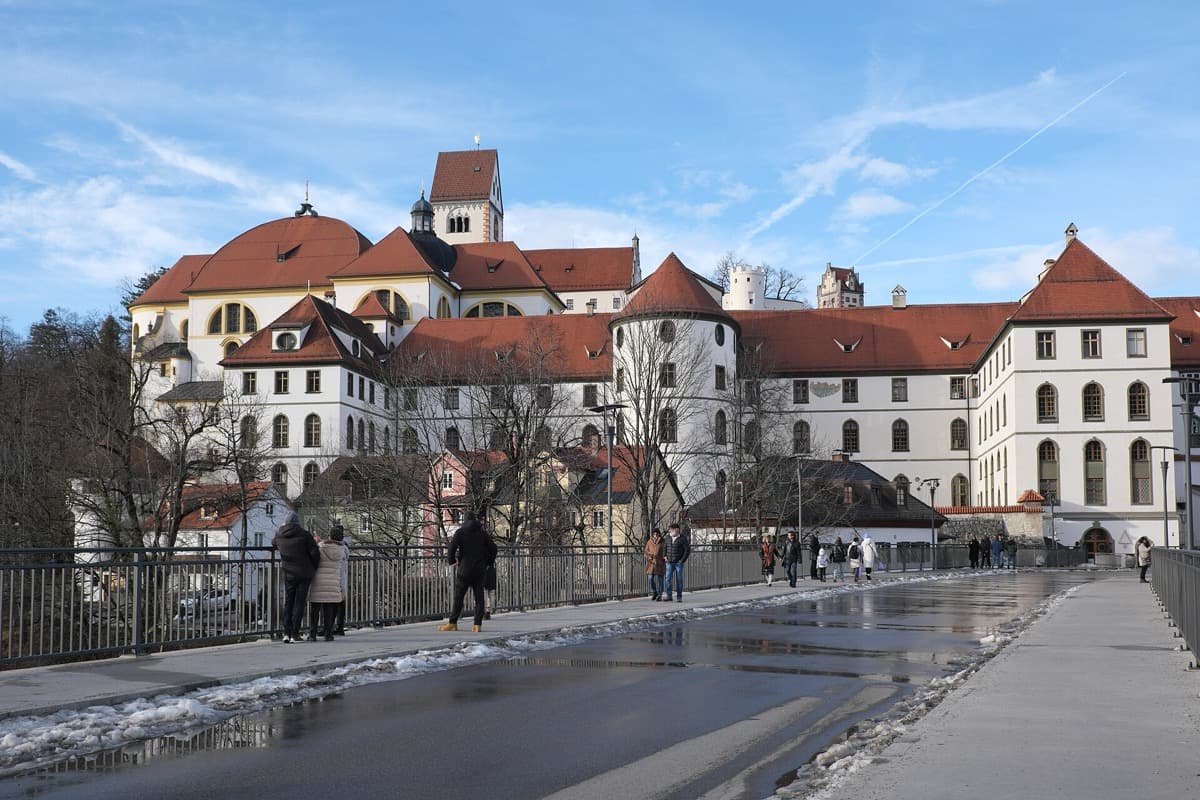 A river bridge and monastery buildings on the bank in winter
