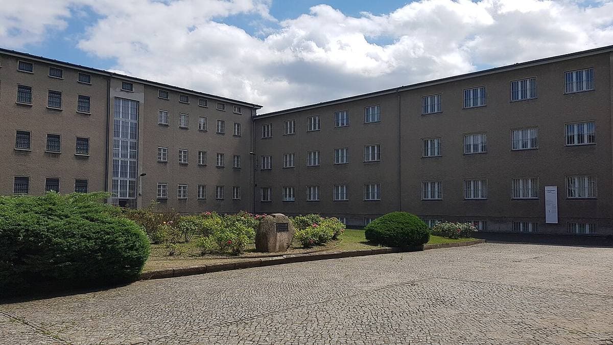 A cobbled yard ringed by the grey prison buildings at Hohenschönhausen