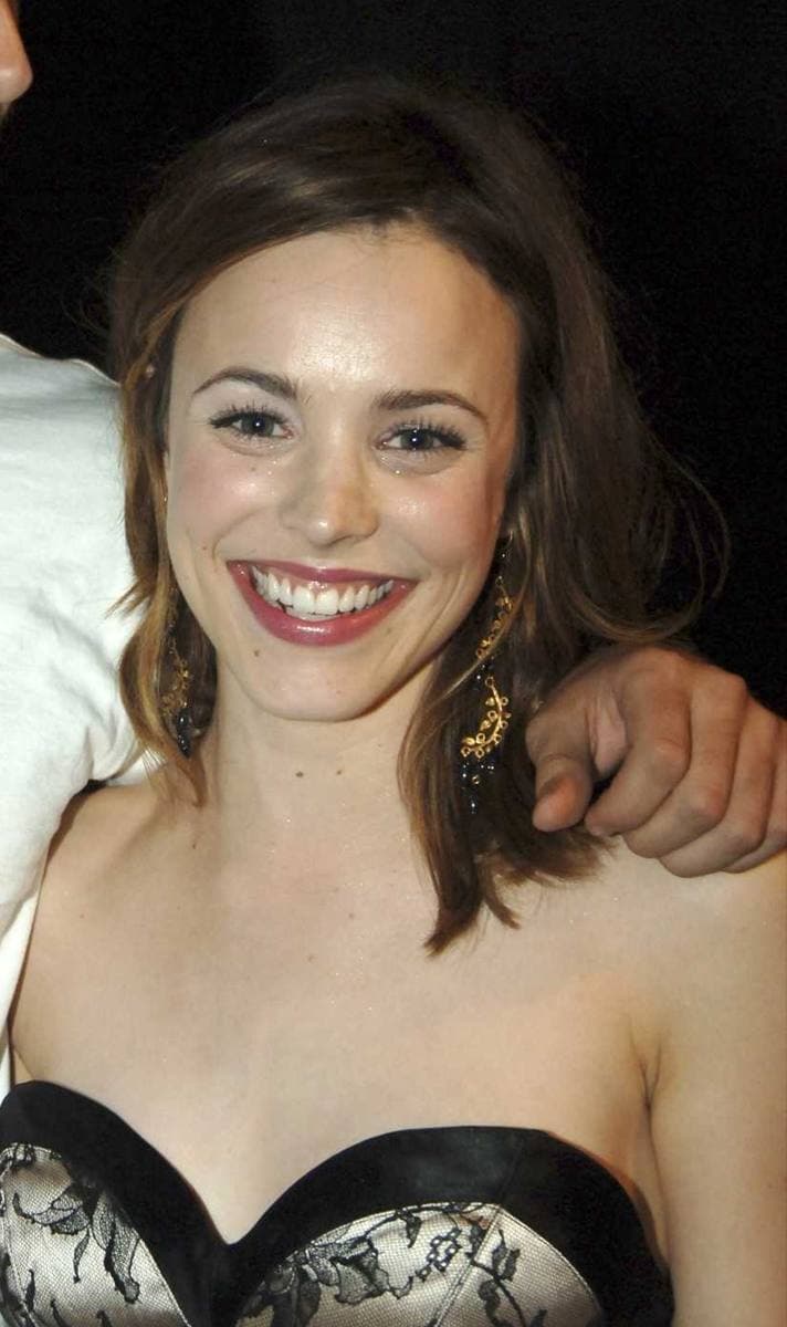 Rachel McAdams smiling, in a black strapless dress