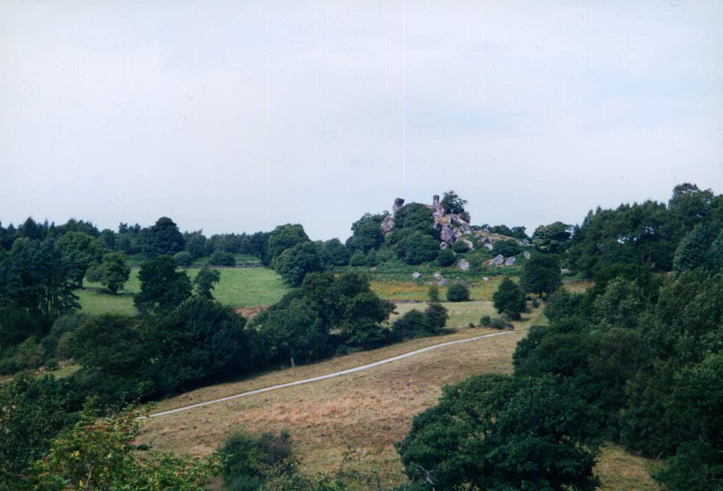 Two gritstone outcrops on a hilltop in Derbyshire.