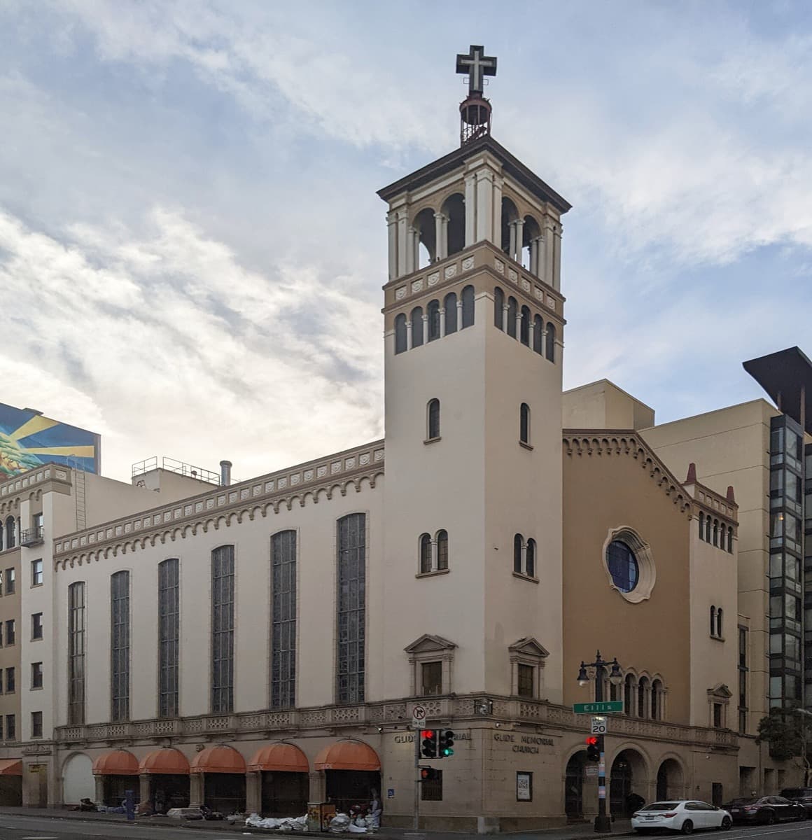 The street front of a church with a tall tower sign