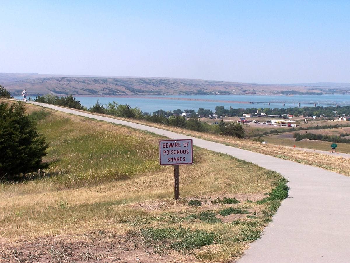The wide Missouri River with a bridge and bluffs at Chamberlain
