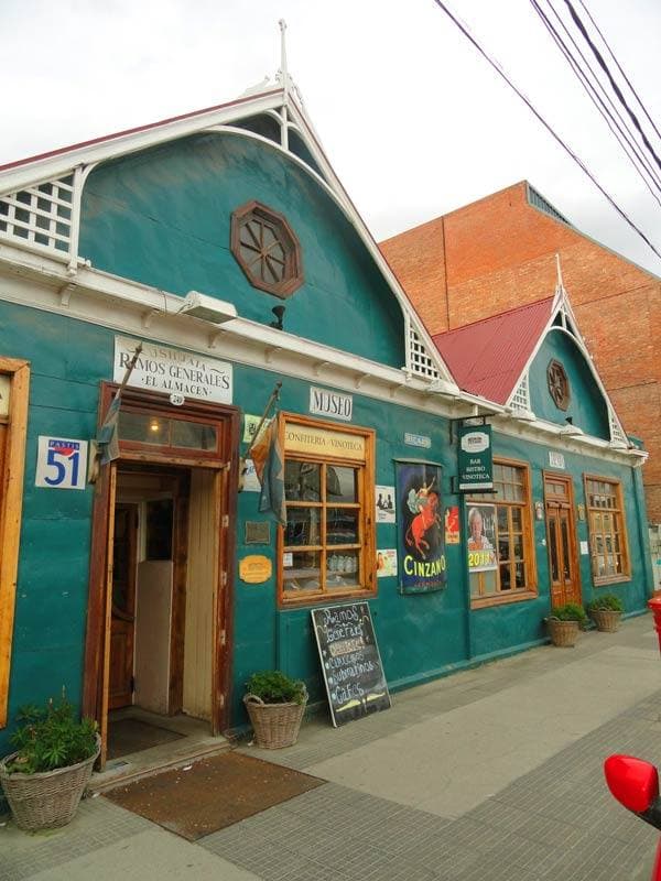 A green wooden shopfront on a Ushuaia street