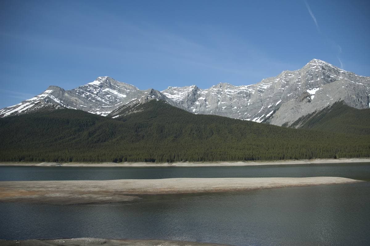 A mountain lake below snow-streaked peaks