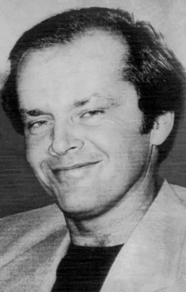 Jack Nicholson smiling, in a black-and-white press photograph