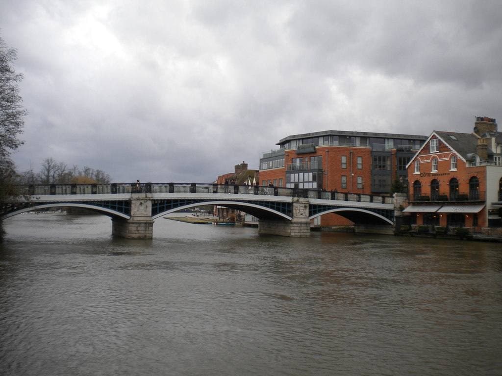 A low iron footbridge over a grey river