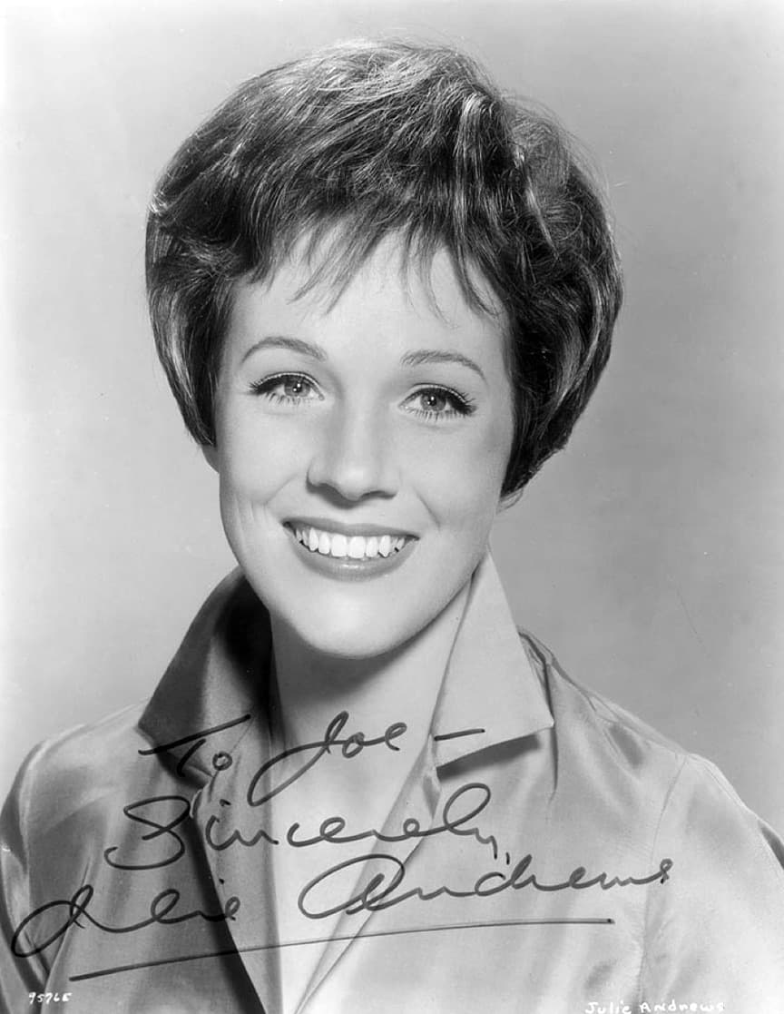 Julie Andrews smiling, in a signed black-and-white portrait