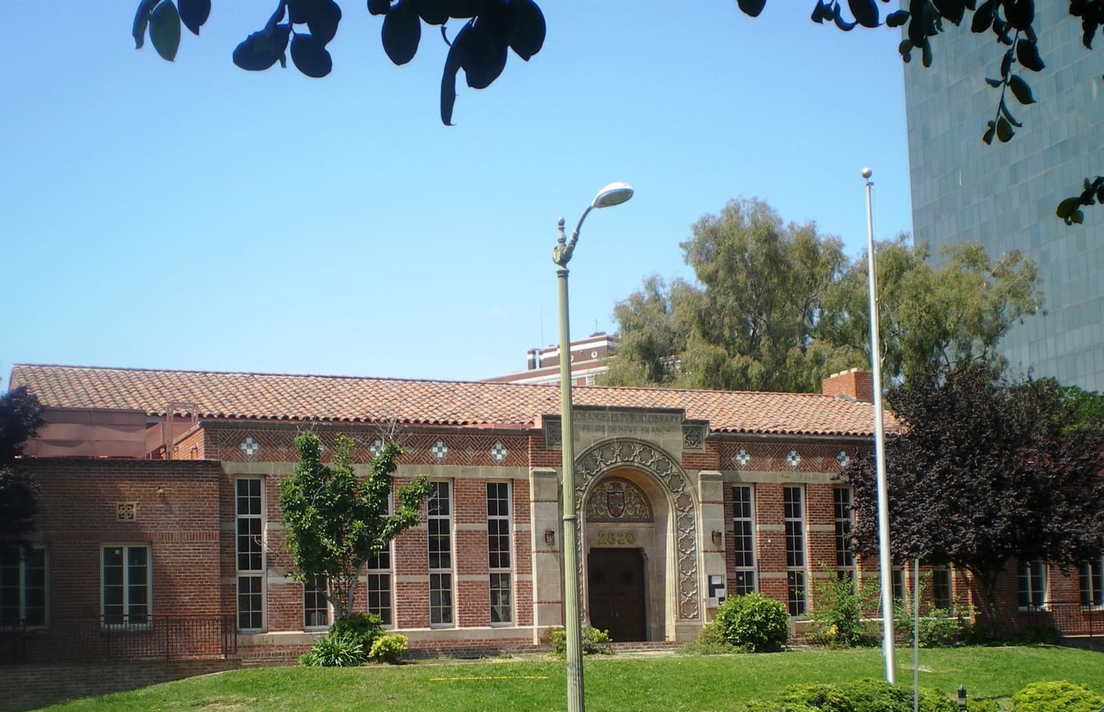 A Spanish-style library among trees in a city park