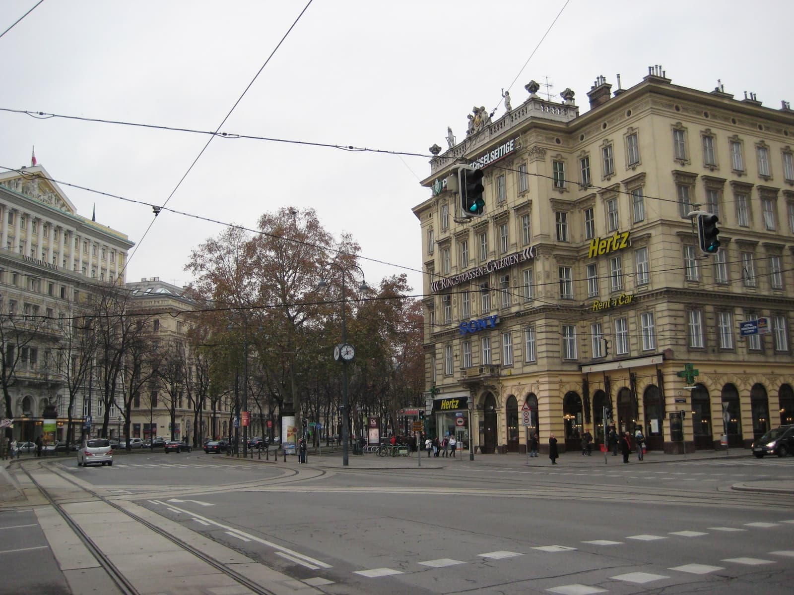 A grand ochre hotel on a wide tramway corner