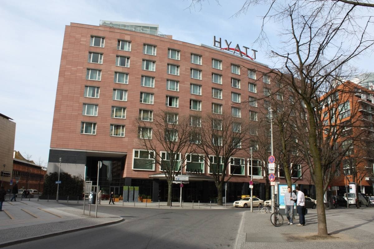 A modern brick hotel on a Berlin square with bare trees