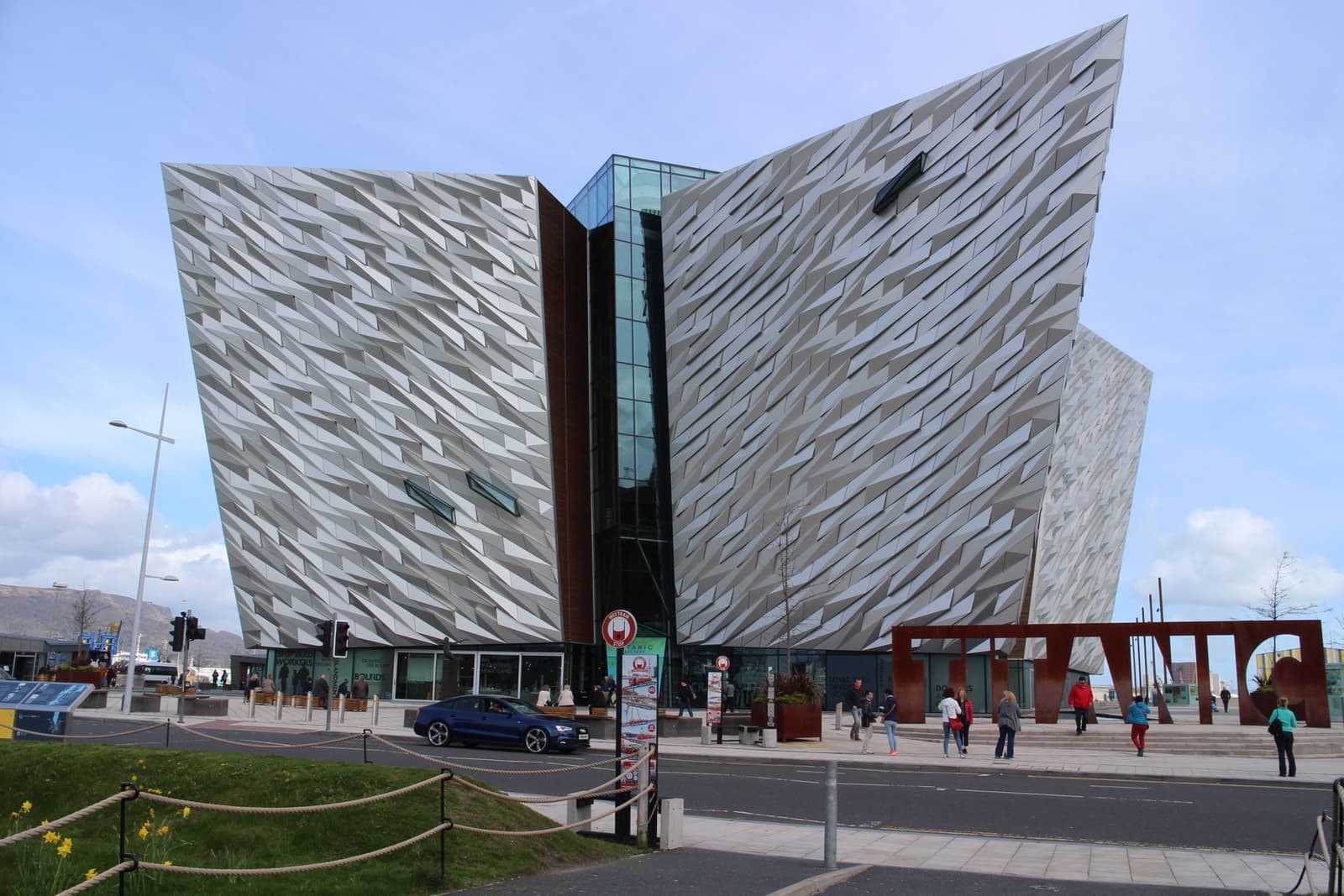 A building of four angular silver wings, each the height of the ship's hull