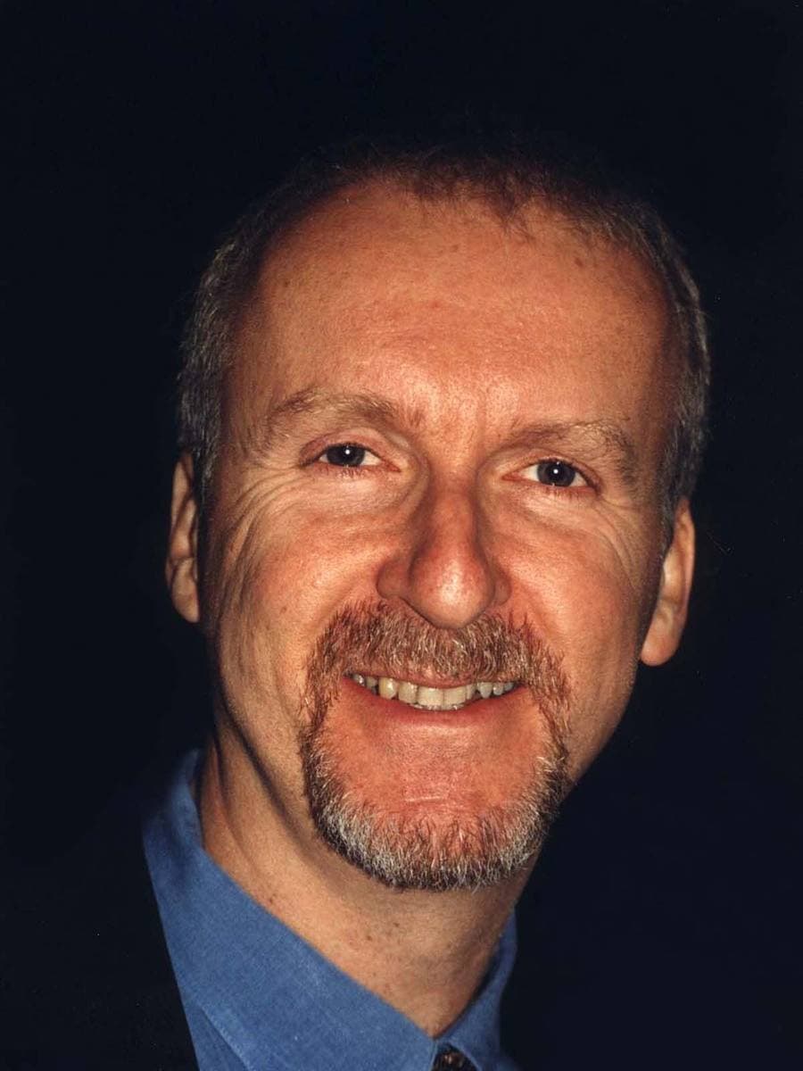 James Cameron smiling, with a goatee, in a blue shirt and tie
