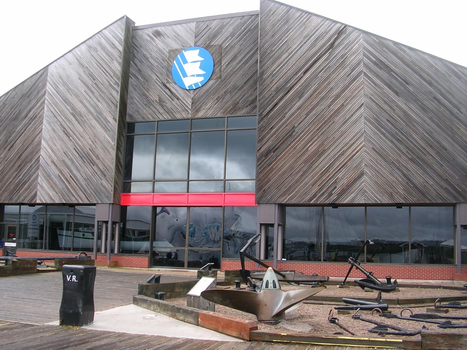 A wooden-clad museum front with an anchor outside