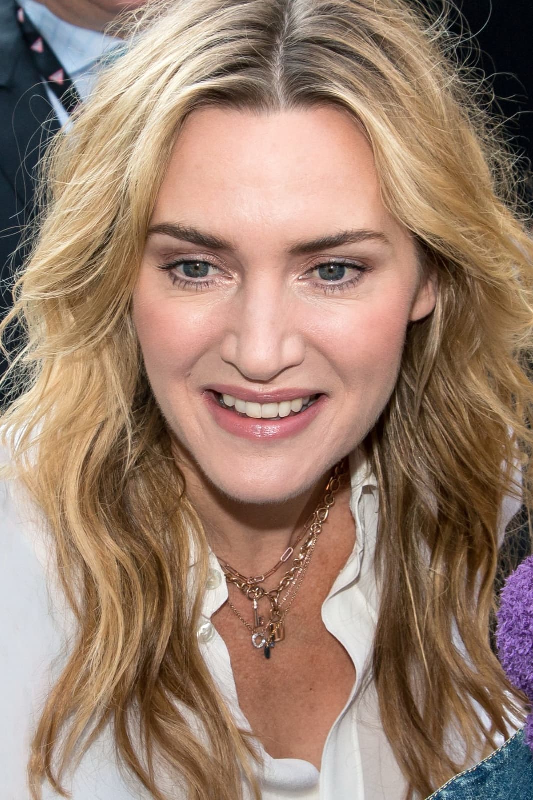 Kate Winslet smiling, long fair hair, at a film festival