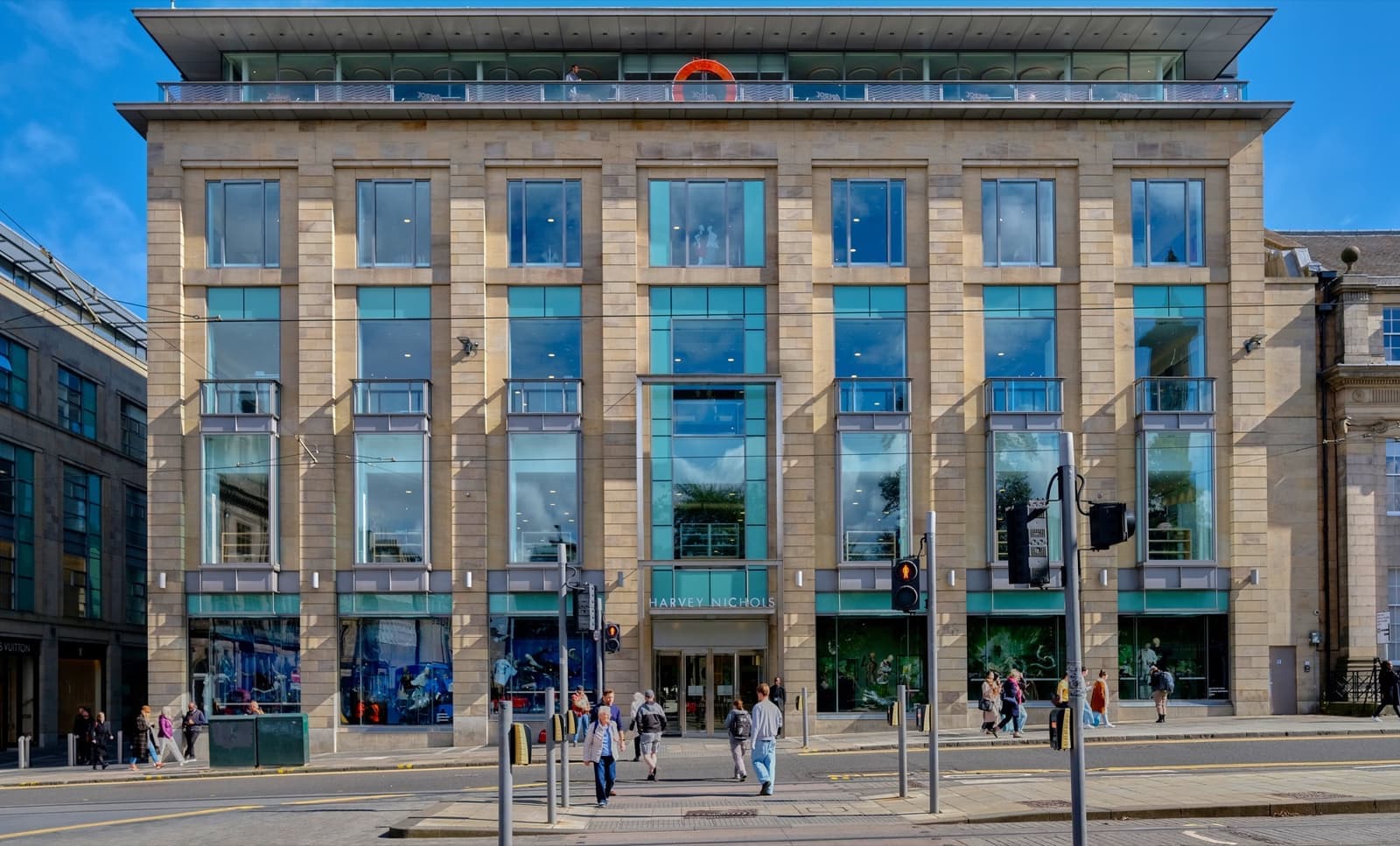 A stone and glass department store with tall windows
