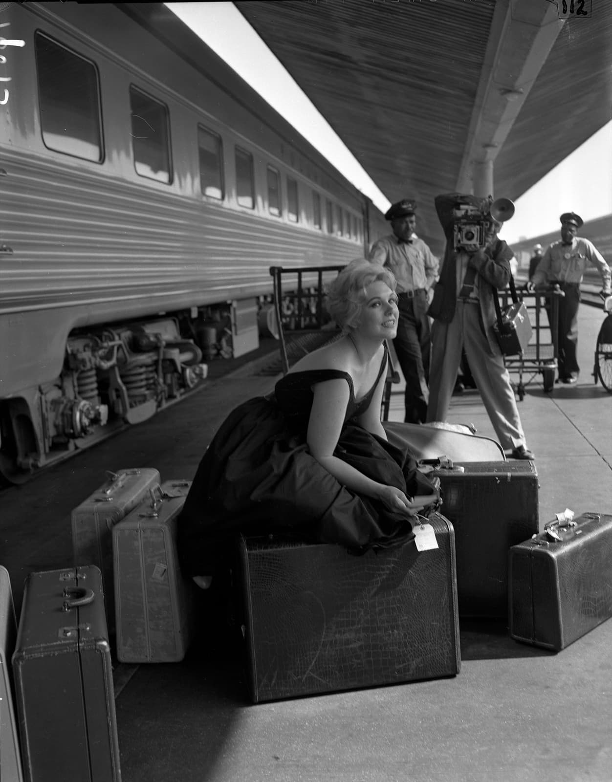 Kim Novak posing on a station platform