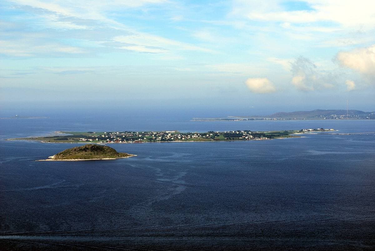 Low green land and sea on the island of Giske