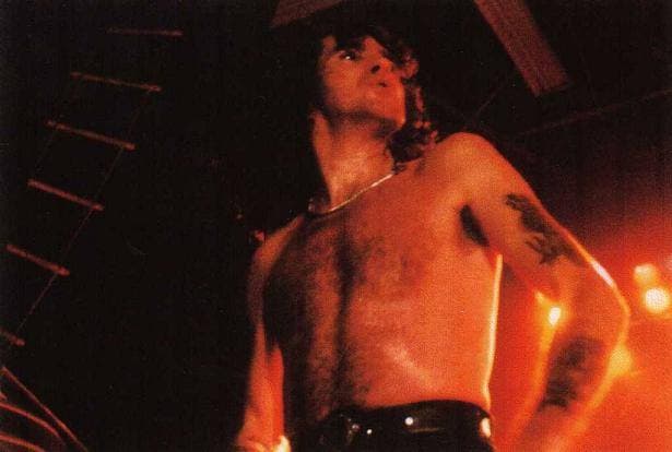 Bon Scott singing on stage, bare-chested, in Grenoble in 1979