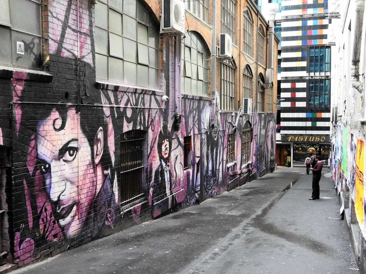A narrow city lane with walls painted from end to end