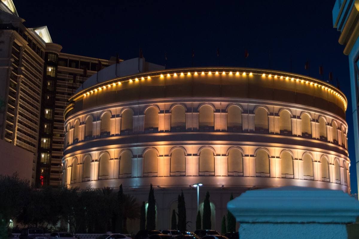 The round, column-ringed Colosseum at Caesars Palace lit gold at night