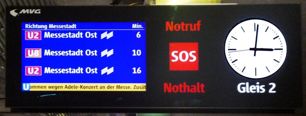 A station display listing trains to Messestadt Ost, with a note about the Adele concert at the Messe
