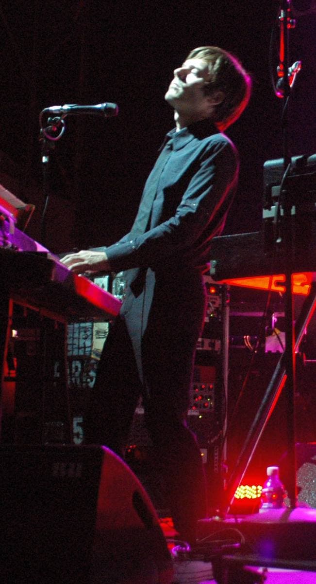 Jean-Benoît Dunckel in a dark shirt at a keyboard, head tilted back, eyes closed