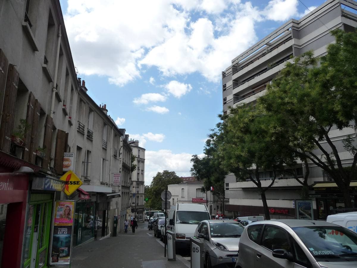 A long Paris street climbing uphill between apartment buildings