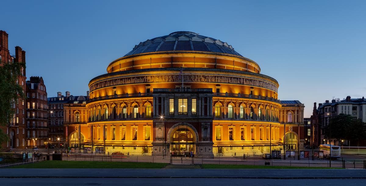 The round red-brick Royal Albert Hall under a pale sky