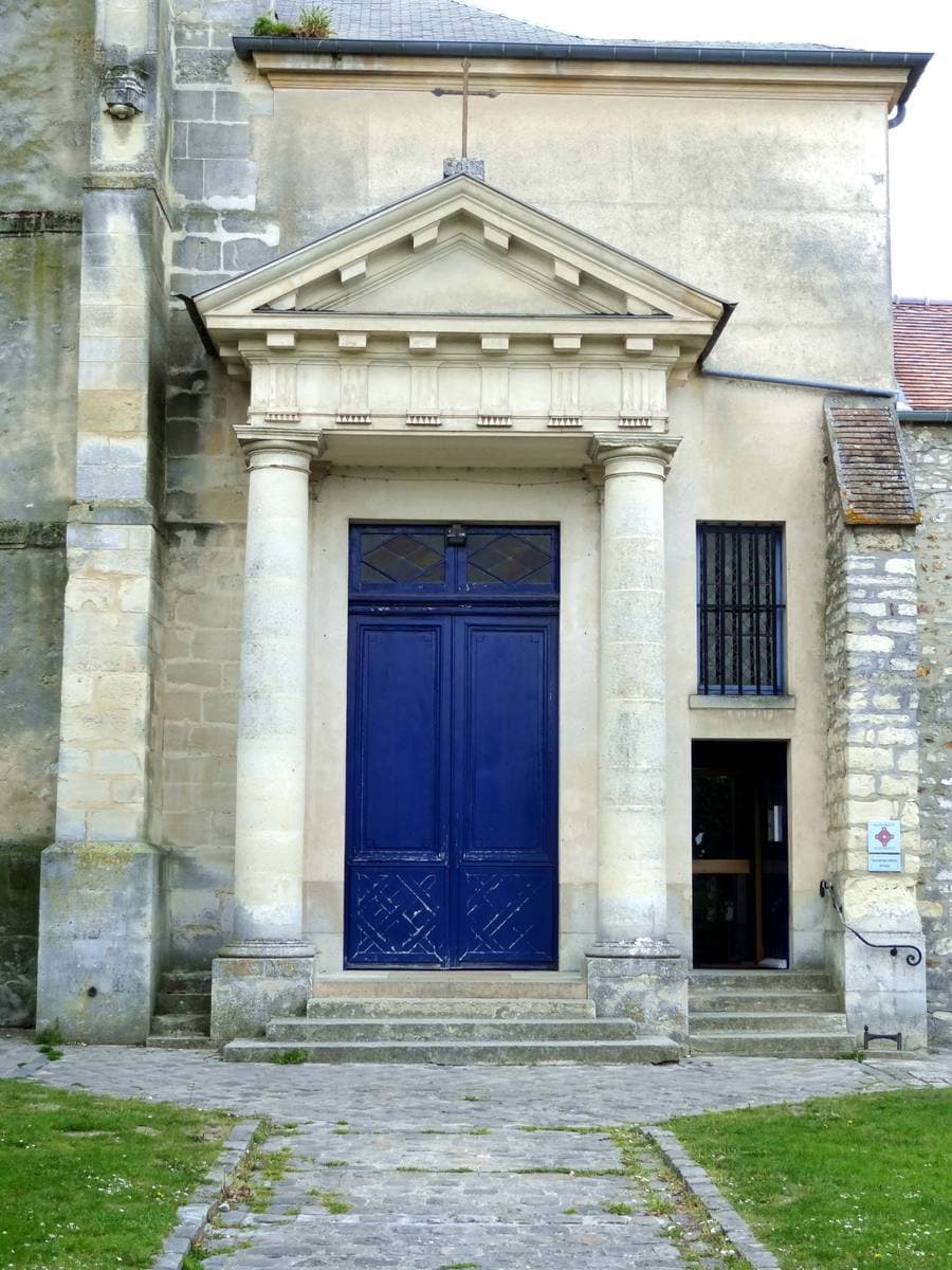 The stone west front and bell tower of a small village church