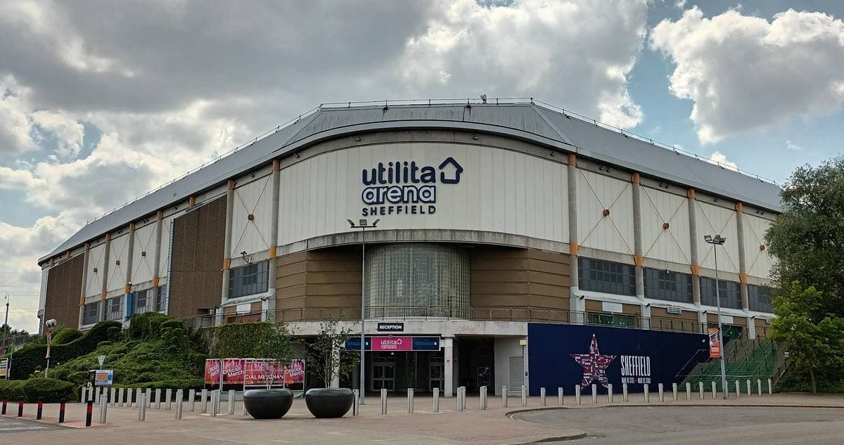 A low, wide arena with a curved silver roof and a Utilita Arena sign over the entrance