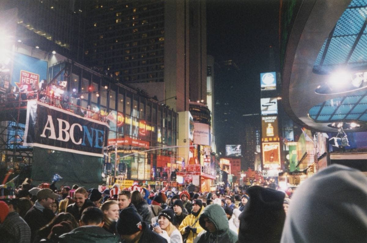 A packed crowd in Times Square at night under bright signs, 1 January 2000
