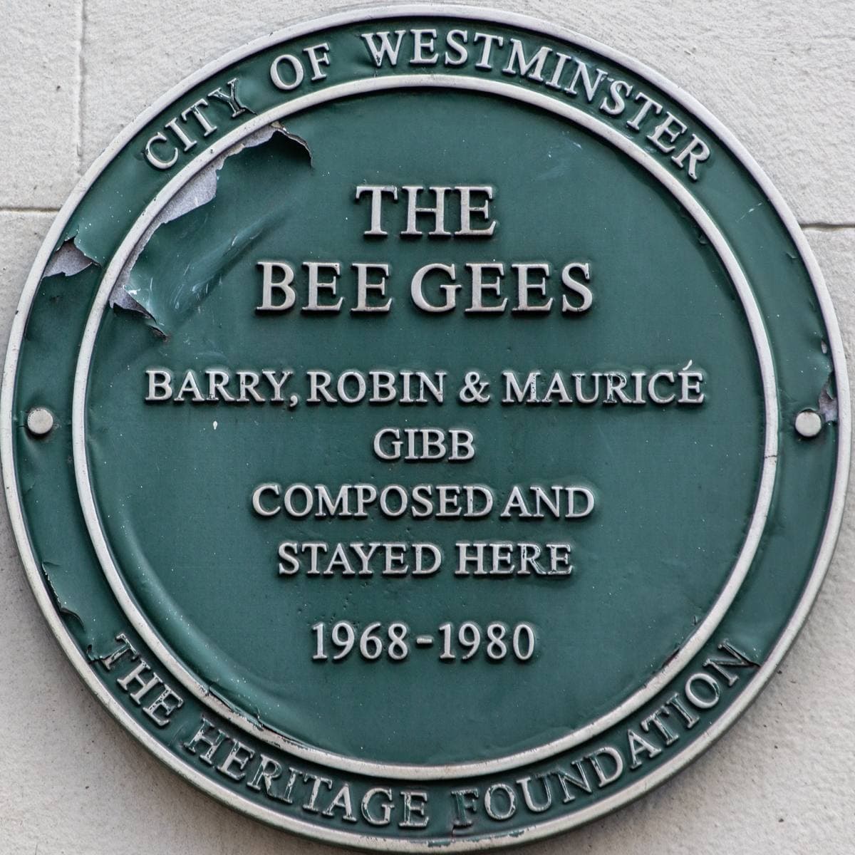 A round green plaque naming the Bee Gees, Barry, Robin and Maurice Gibb, 1968 to 1980
