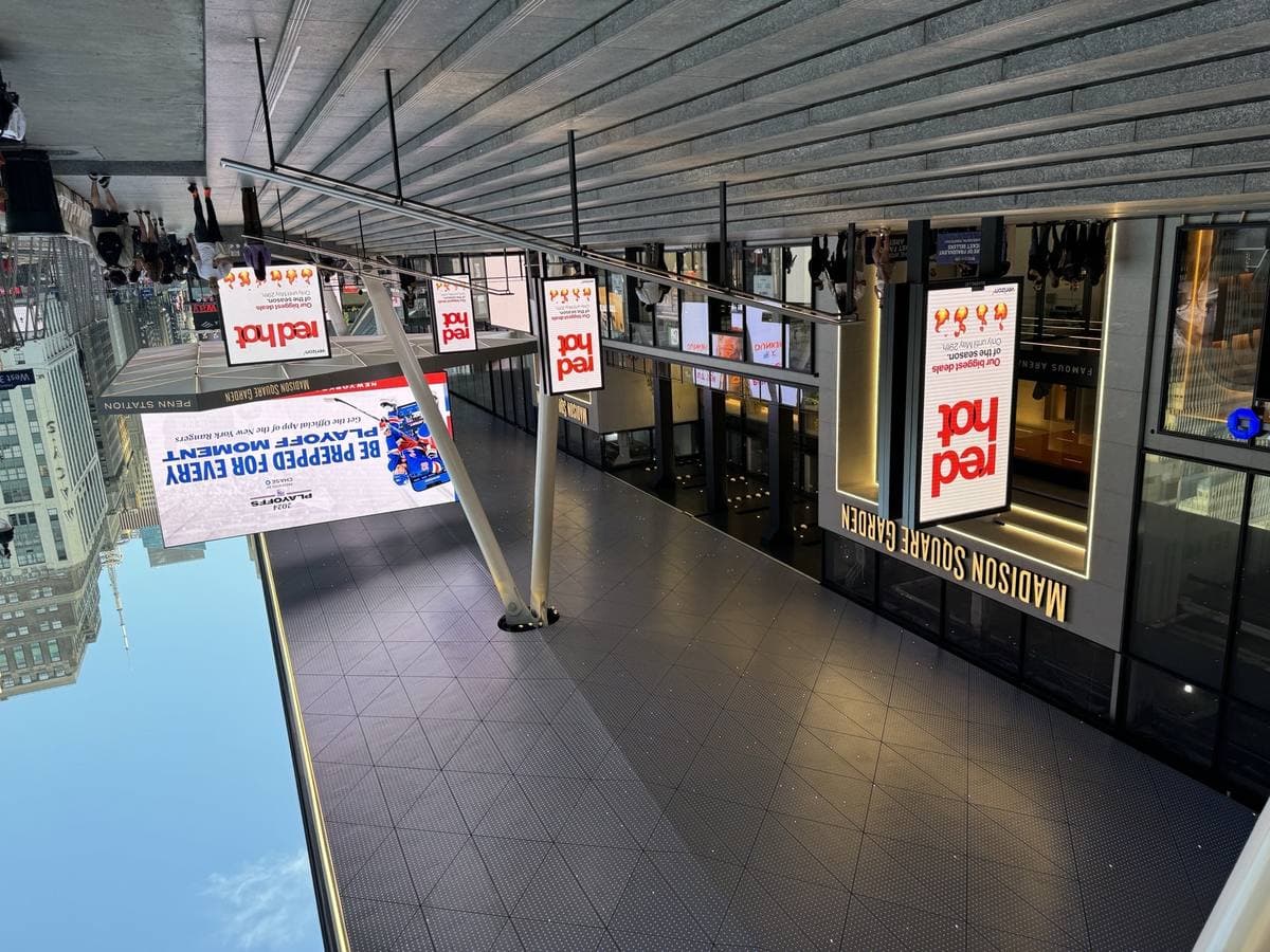 A wide flight of steps under a canopy up to Madison Square Garden, with screens and banners