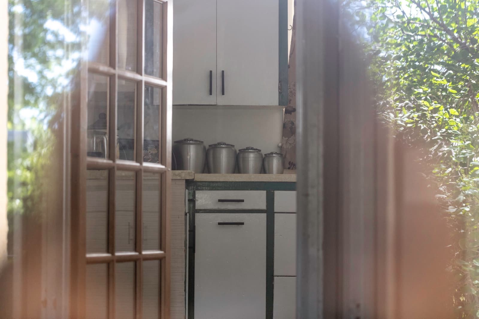 A small 1950s kitchen with pale cabinets