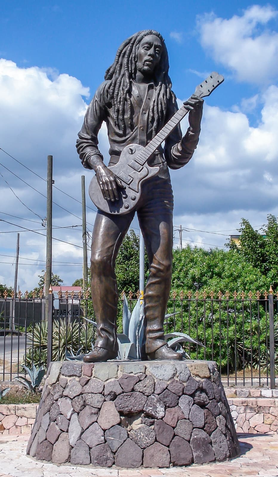 A bronze statue of Bob Marley holding a guitar