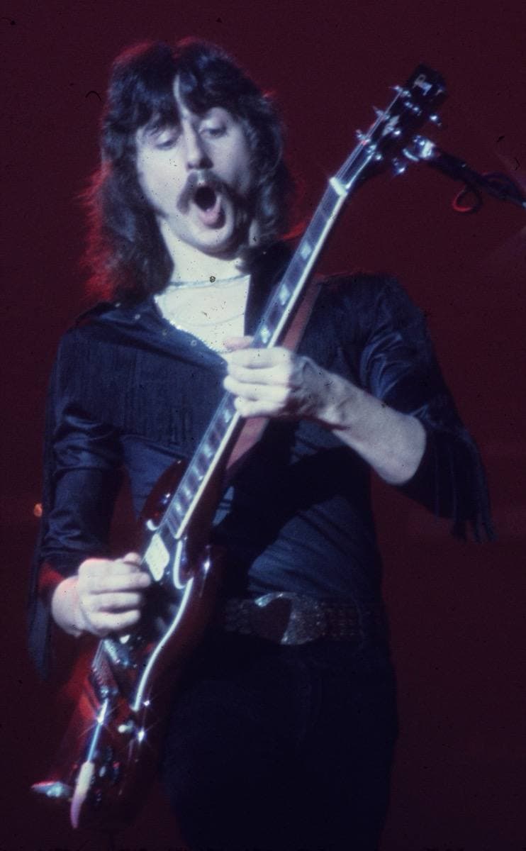 Barry Goudreau playing an electric guitar on stage in the 1970s