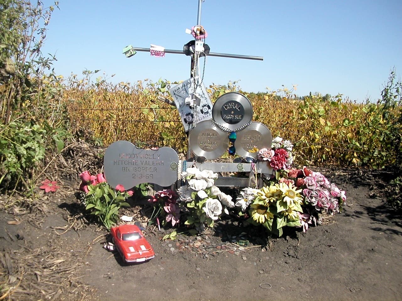 A small memorial at the edge of a cornfield