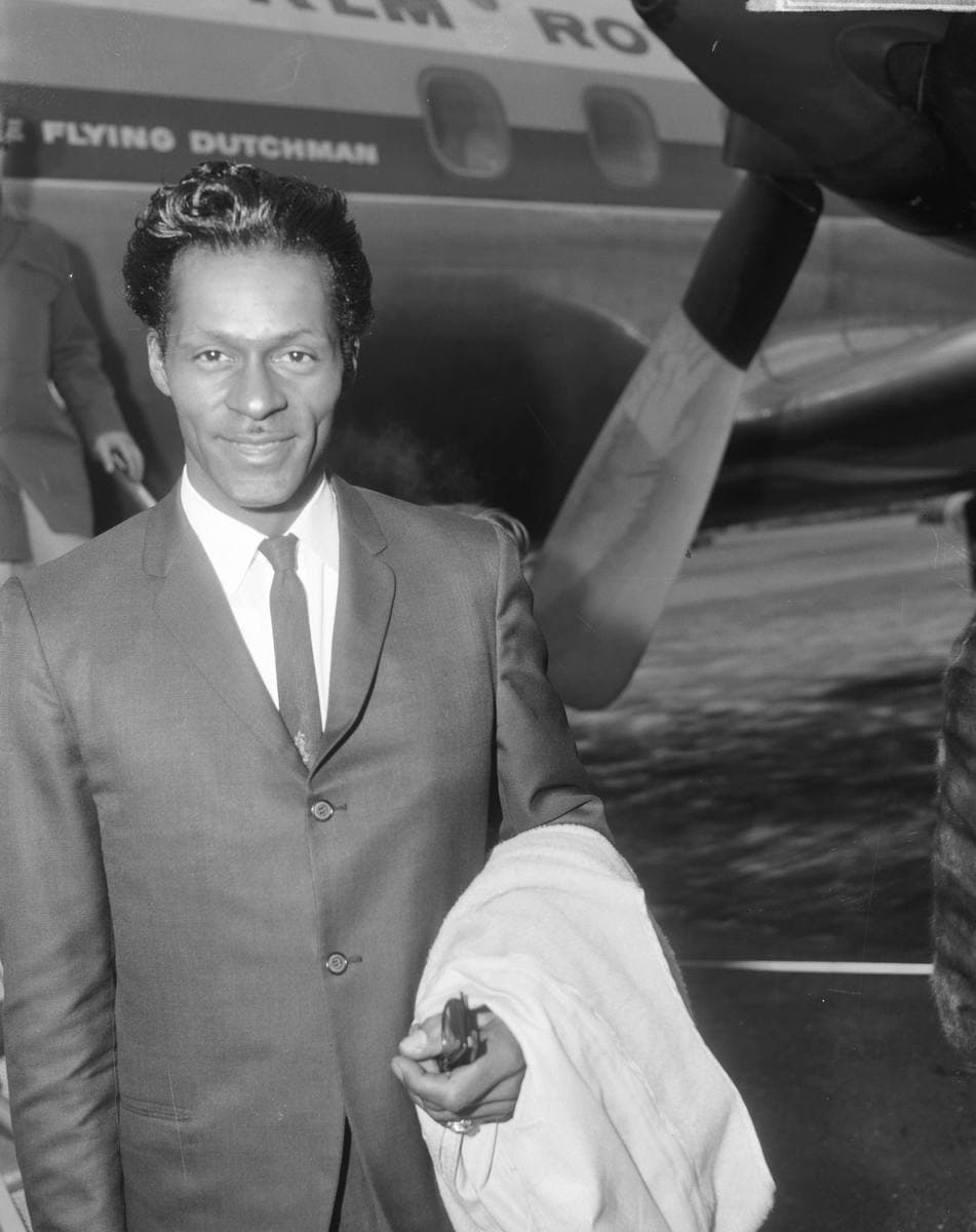 Close portrait of Chuck Berry with a pencil moustache, looking to one side