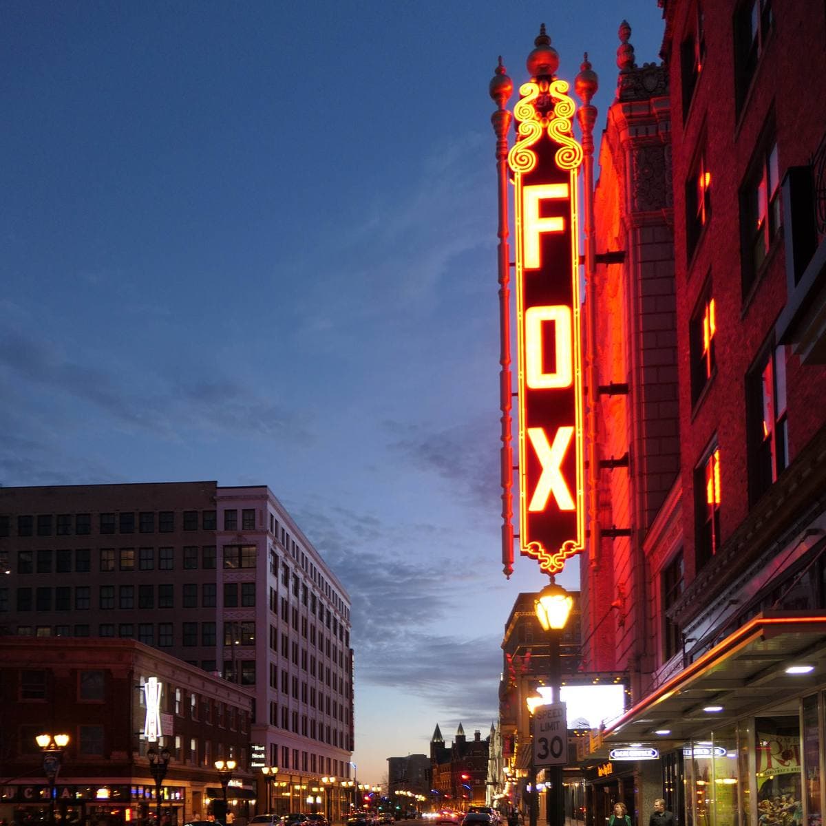 The lit front and marquee of the Fox Theatre at dusk