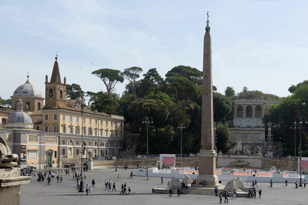 The Egyptian obelisk in the centre of Piazza del Popolo under a blue sky
