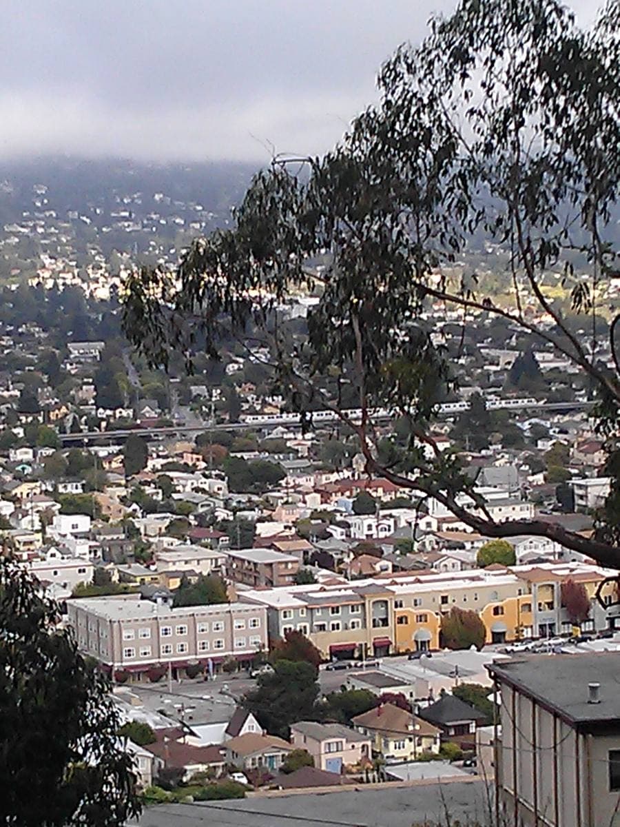 A view over El Cerrito with a train and hills behind