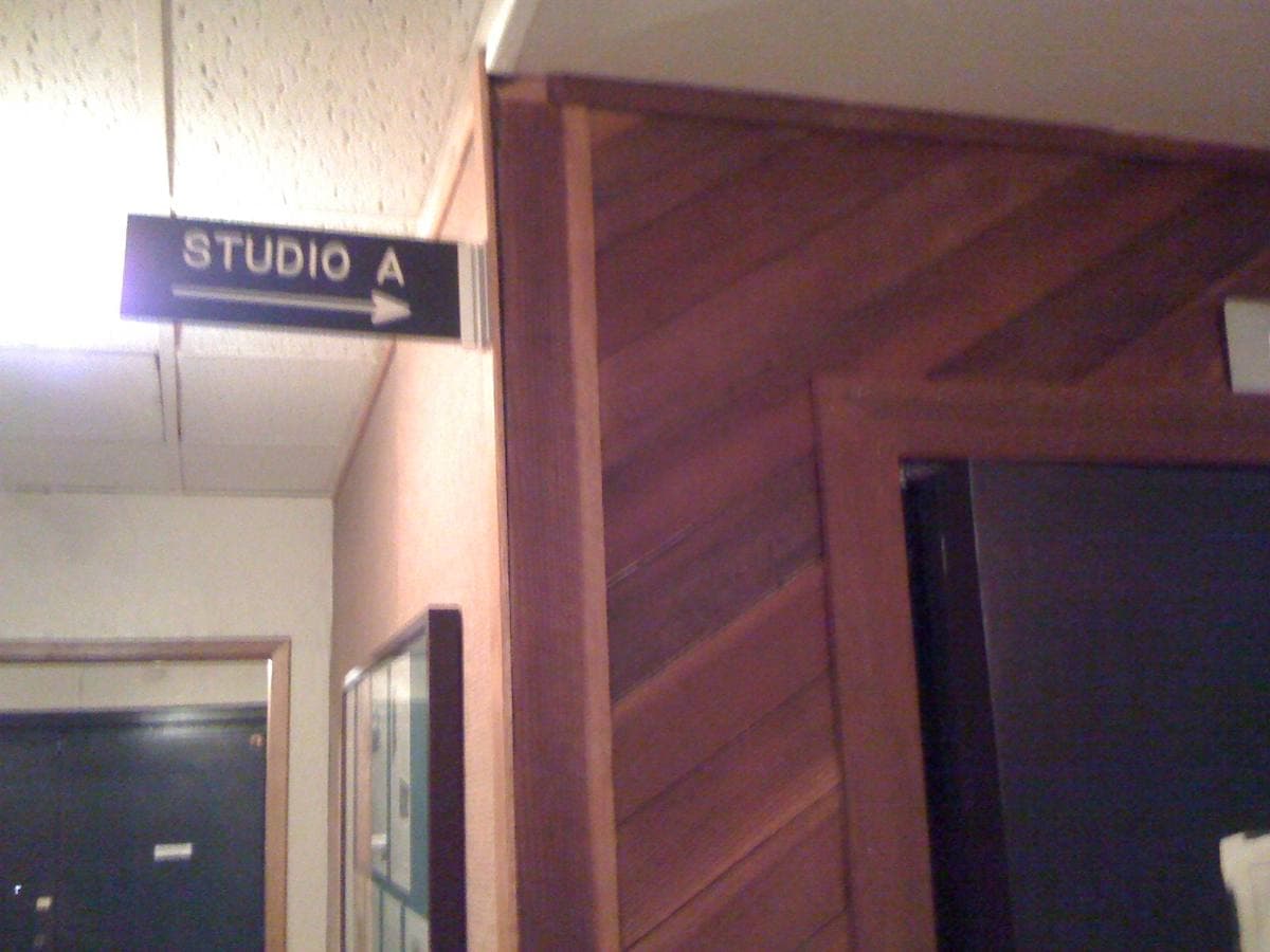 A corridor with a Studio A sign and wood-panelled walls