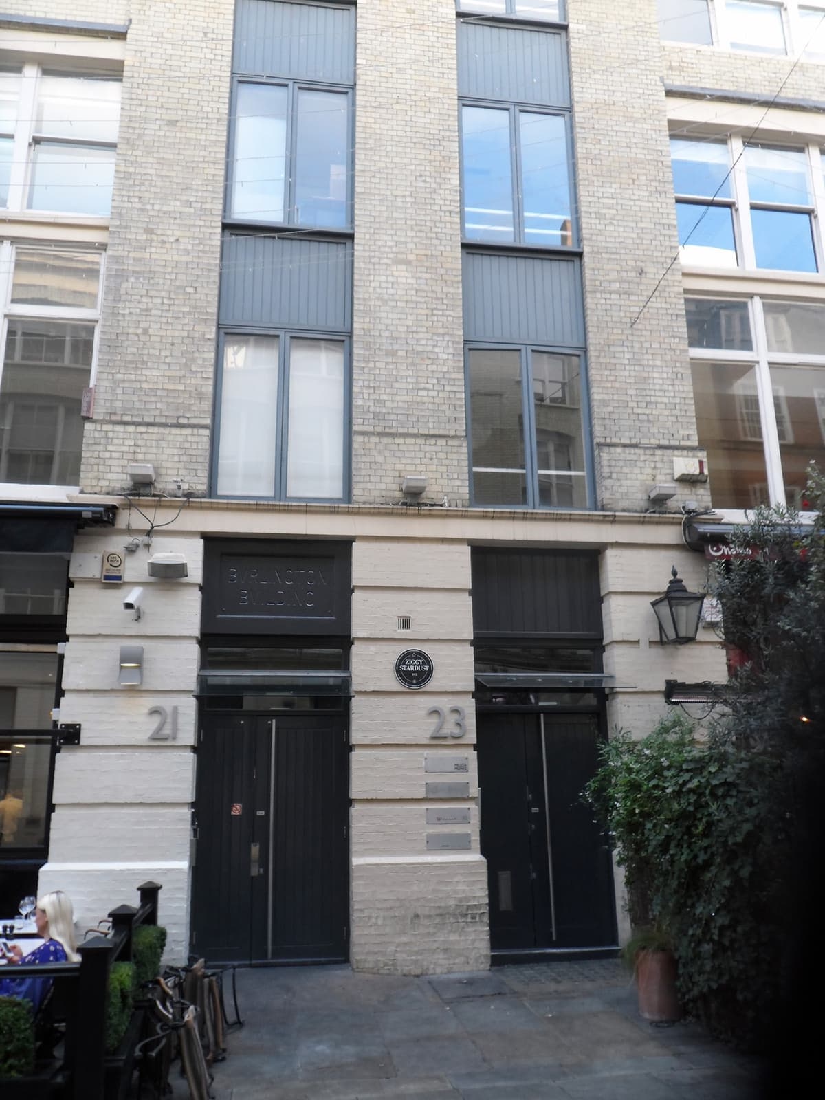 The doorway at 23 Heddon Street with a black plaque beside it