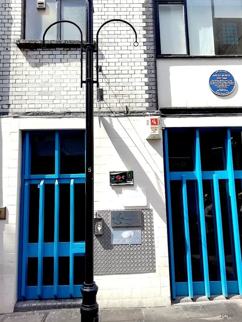 A narrow Soho building with a blue plaque