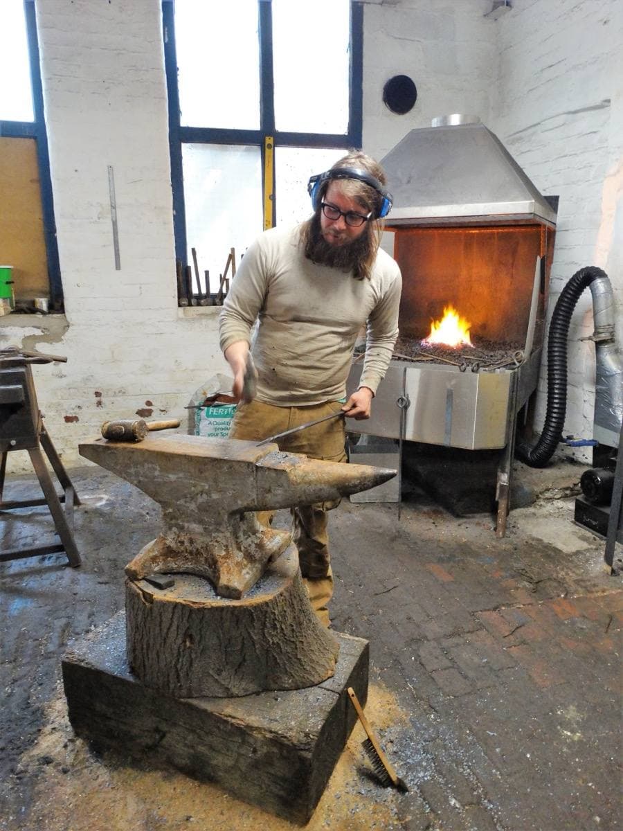 A working blacksmith’s forge with tools hanging inside Portland Works