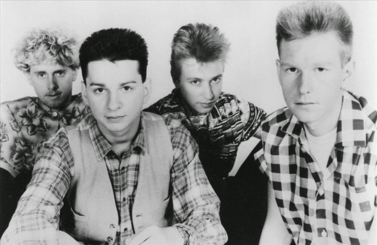 Four young men standing in a row in a black and white press photograph