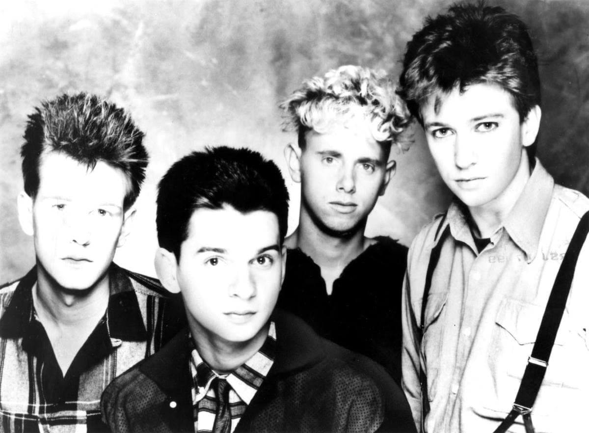 Four men in a group press portrait from the early 1980s