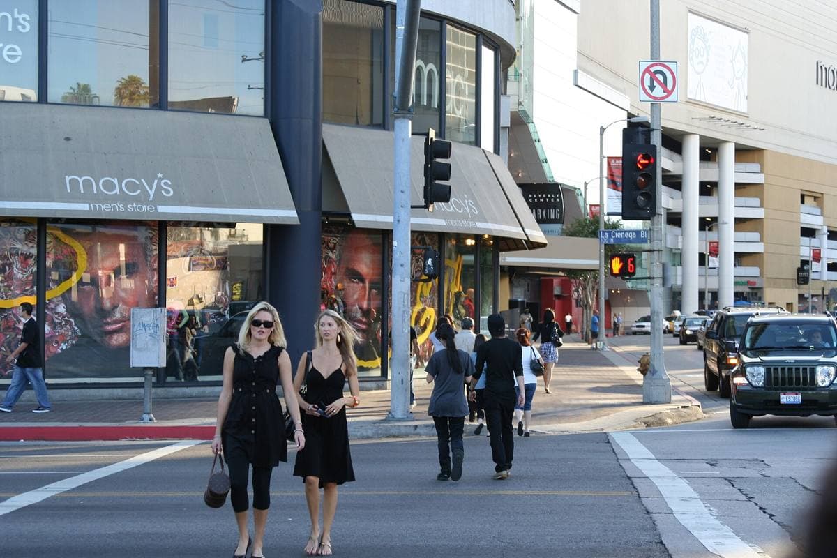 A large windowless shopping centre on the corner of a wide boulevard